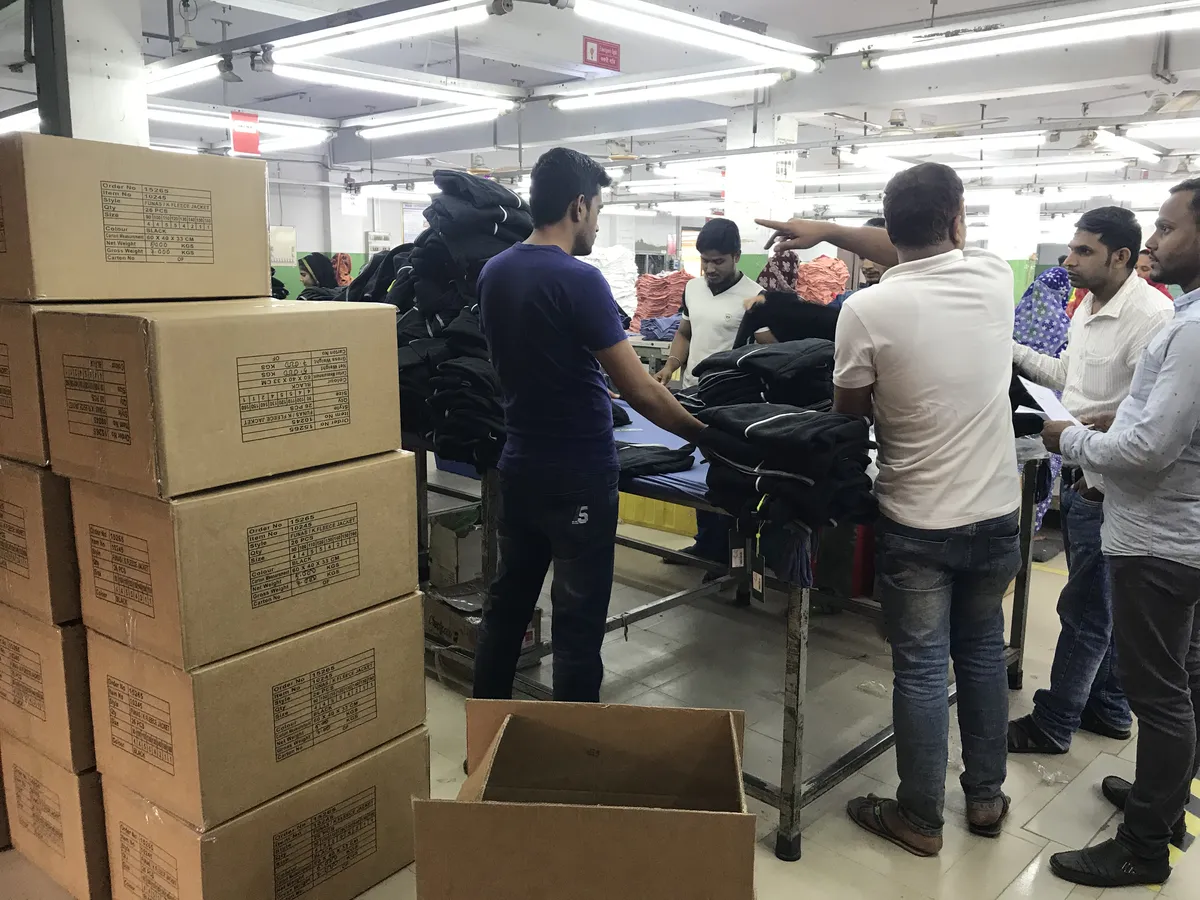 Packing finished garments into shipping cartons
