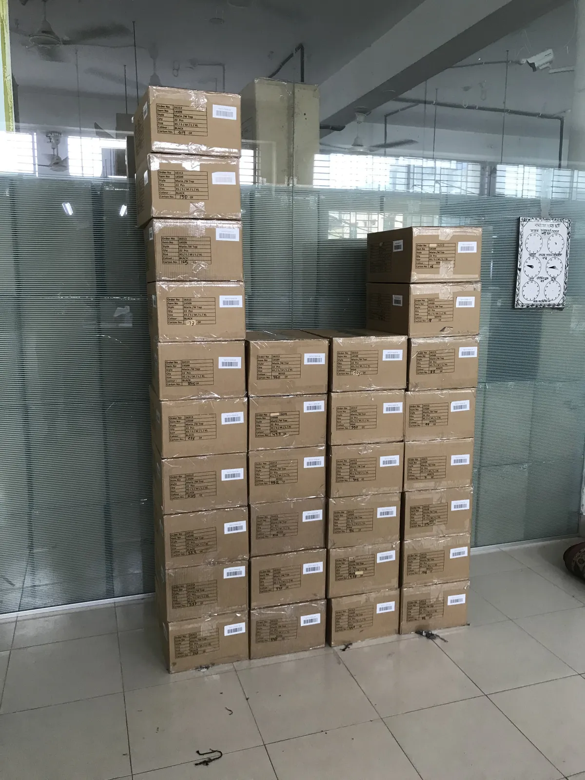 Stacked cartons of finished, packed garments
