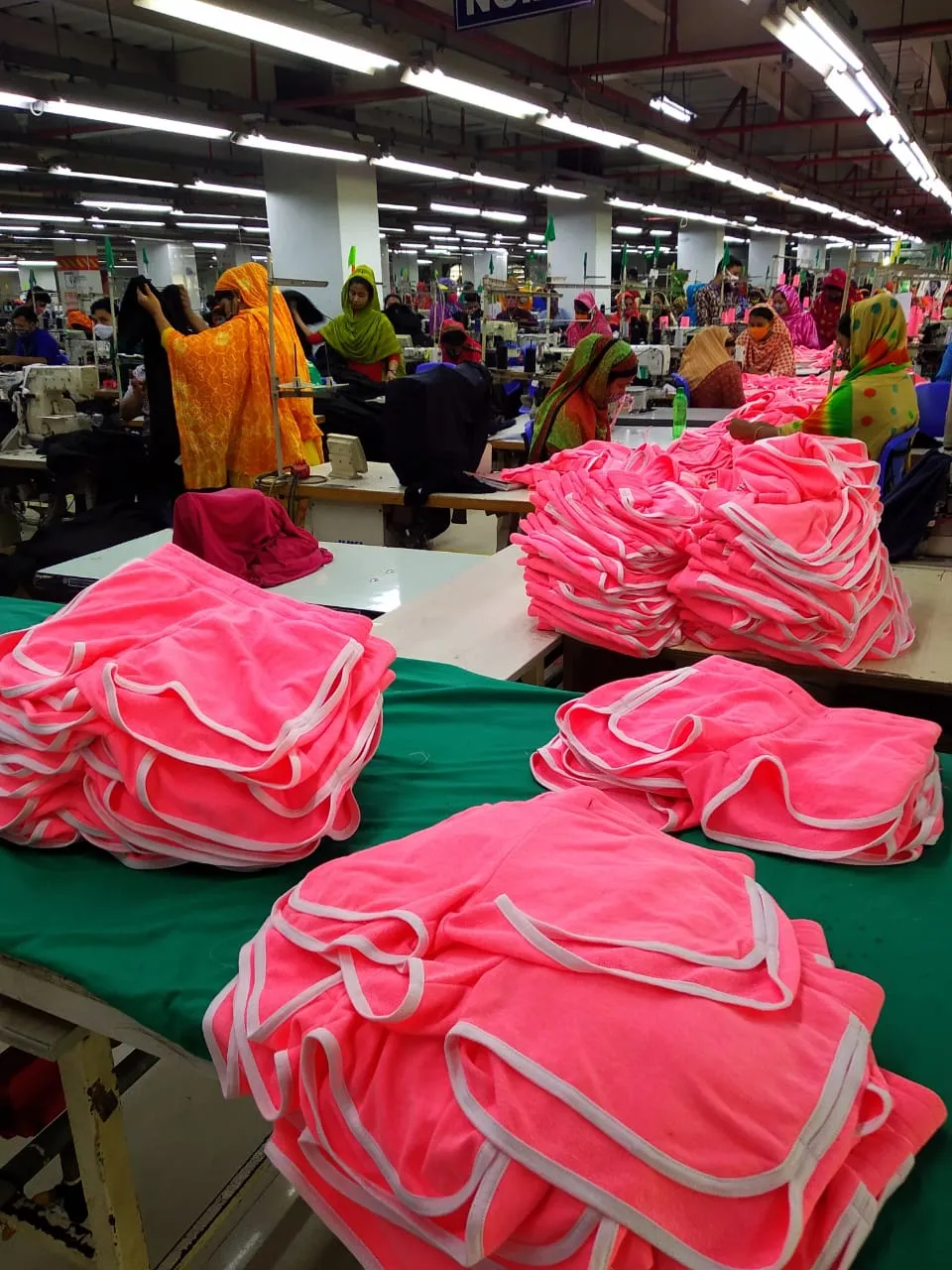 Finished pink garments folded and ready for packing
