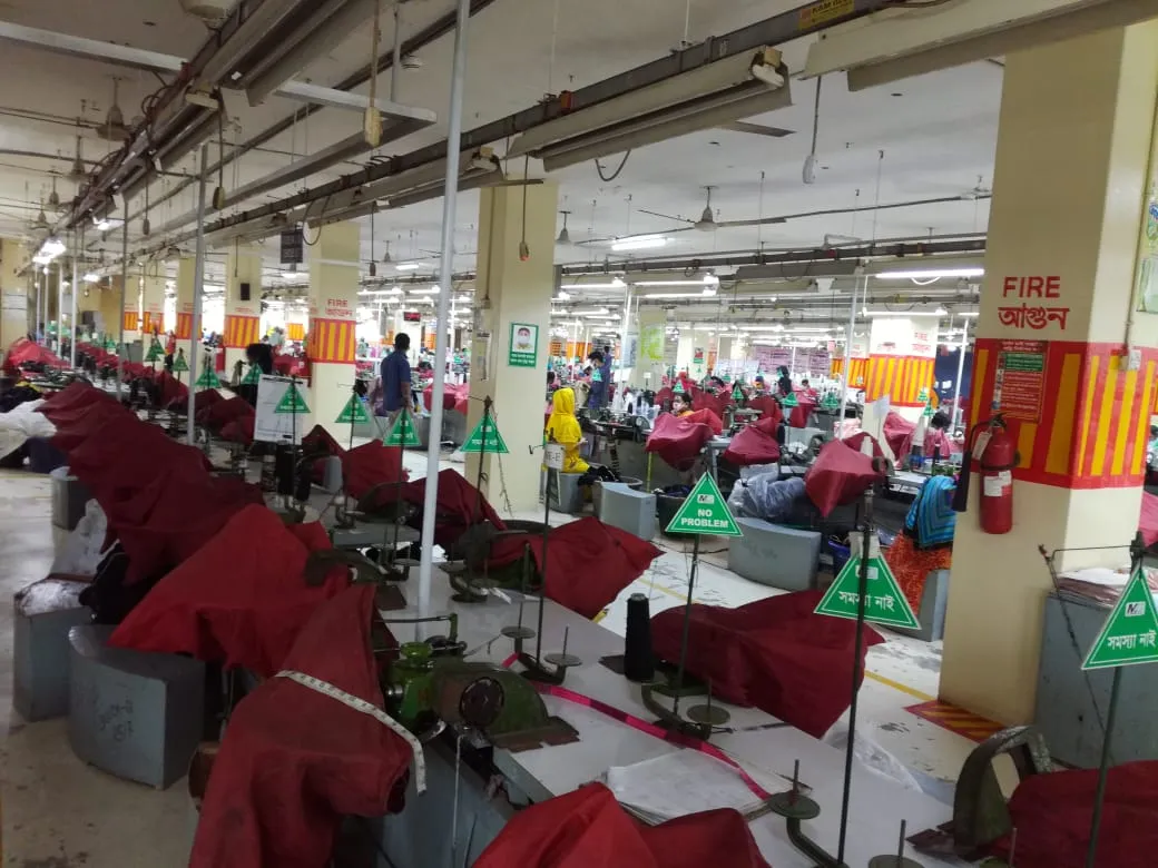 Stacks of finished red garments at the quality table