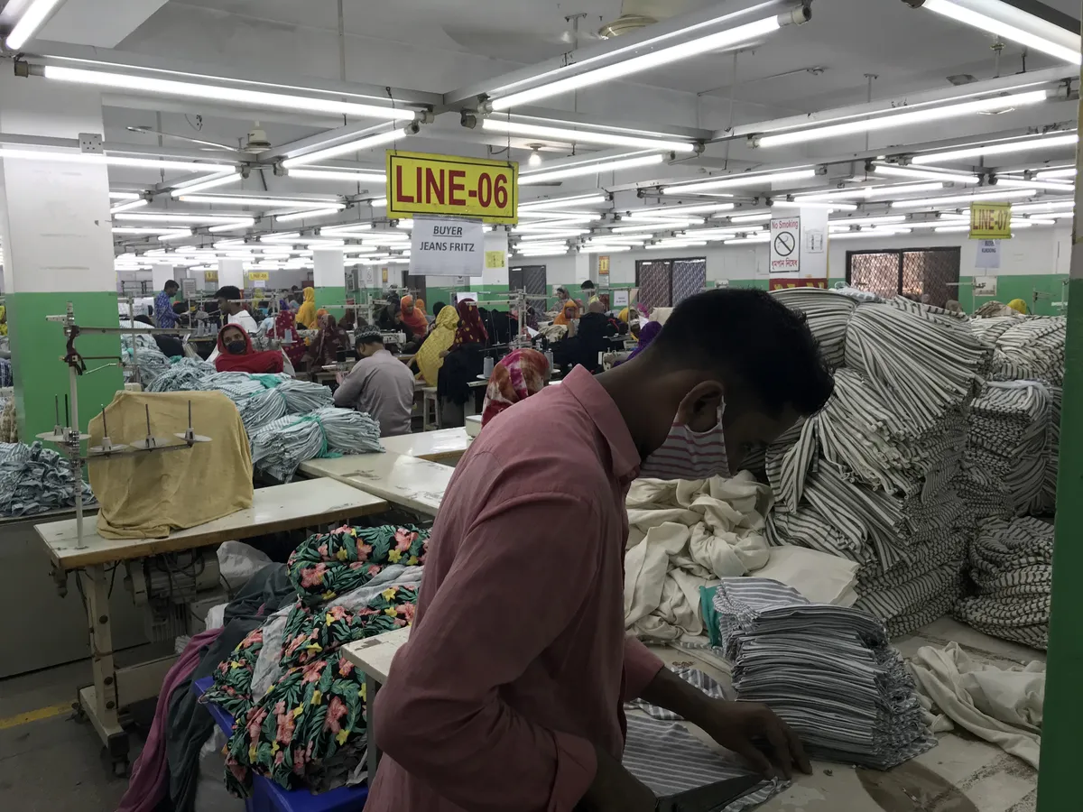 Operators stitching on the production line
