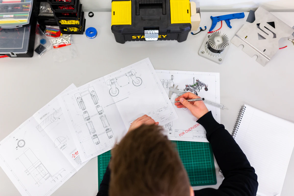 Technical drafting and measurement review during apparel product development at Essential Group