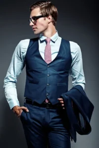 young-elegant-handsome-businessman-male-model-blue-suit-fashionable-glasses-posing-studio_158538-2172